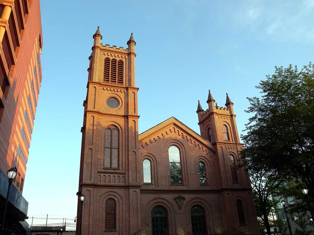 Looking south from Jamaica Avenue at First Reformed Church of Jamaica at dusk of a sunny day. NYCLPC designation 1966.