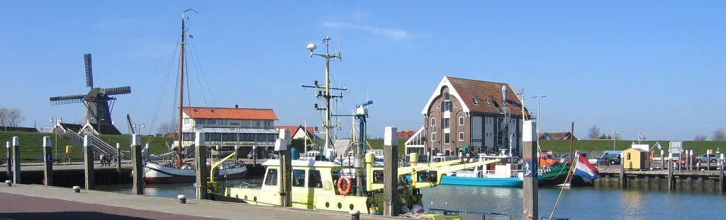 Harbour of Oudeschild, Texel, Netherlands. Wind mill and office visible.