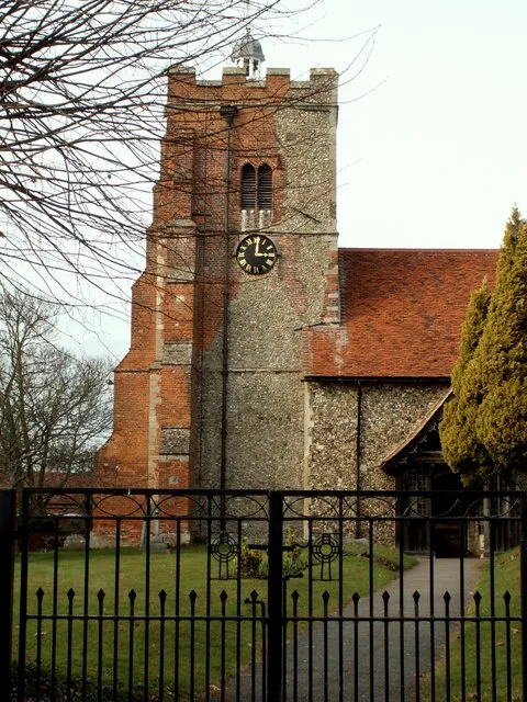 West tower of St Martin's parish church, Little Waltham, Essex, seen from the south. The Perpendicular Gothic tower was built in the 15th century and much repaired in brick in the 16th and 17th centuries. On its top is a small cupola and weather vane dated 1679.