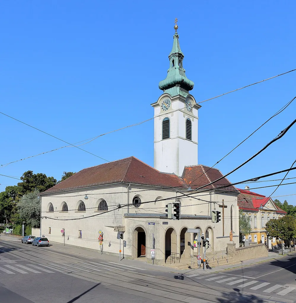 Südwestansicht der Pfarrkirche St. Erhard in Mauer, ein Ortsteil des 23. Wiener Gemeindebezirkes Liesing.Nachdem die alte Pfarrkirche zu klein und ein Hindernis für die neu erbaute Straßenbahn war, wurde die Kirche ab 1934 nach Plänen Clemens Holzmeisters umgebaut. Dabei wurde ein neues Langhaus in Nordsüdausrichtung errichtet und das alte mit der Ostwestausrichtung abgetragen. Der Turm, welcher noch aus der Erbauungszeit stammt, mit seinem Zwiebelhelm von 1770 und der gotische Chor blieben erhalten, wobei der Chor zur Erhardskapelle umgestaltet wurde. Am 14. November 1936 erfolgte die Weihung der neuen Kirche.