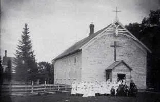 19th century view of the original St. Joseph's Church in Elkader, Iowa. The building still stands on the church property and has been converted into a parish hall. It, along with the present church, are listed on the National Register of Historic Places.