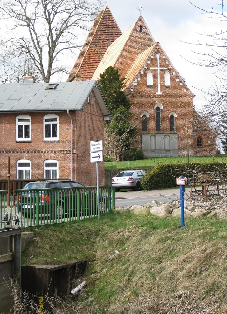 Church in Herrnburg, municipality of Lüdersdorf in Nordwestmecklenburg. In front of the picture sluice of Palingen creek coming from Palingen. The former water mill is on the other side of the road.