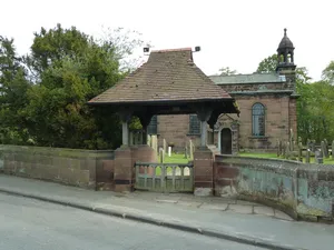 Churchyard wall north and east of St Peter's church, and lychgate