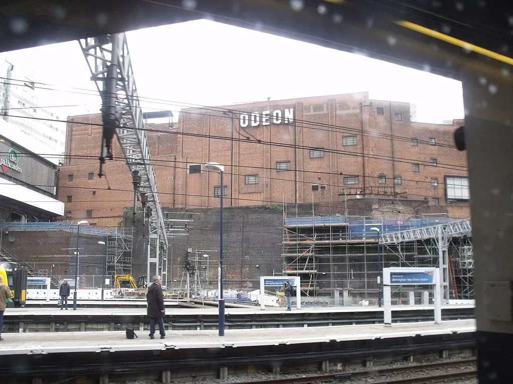 After getting back onto another London Midland Cross City 323 train, I got off at New Street, and didn't have to go far. The train to Tamworth (going to Nottingham) was on the next platform. Views from the train heading out including the Odeon. The Pallasades is on the left (currently half of what it was since they close most of the shops for the redevelopment of the station). A London Midland Class 350 is on the far left. 350247 A man on the right is taking photos. Will be a new path on that side of the station. Not sure when they will do it and remove the scaffolding.