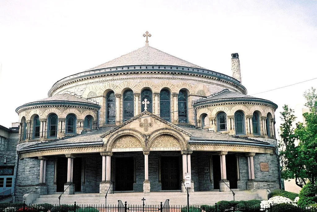 Greek Orthodox Cathedral of the Annunciation (Baltimore, Maryland), a parish of the Metropolis of New Jersey of the Greek Orthodox Archdiocese of America. This circular stone church is one of the most unusual buildings in Baltimore. Designed by Charles E. Cassell in Romanesque style with Byzantine touches, it was built for the Associate Reformed Church in 1889. Left vacant in 1934 and slated to be razed for a filling station, the church was saved through the intervention of the Greek Orthodox congregation, which purchased it in 1937. A Greek inscription, meaning "House of God, Gateway to Heaven" (Gr.: "ΟΙΚΟΣ ΘΕΟΥ - ΠΥΛΥ ΟΥΡΑΝΟΥ"), was carved into the stone above the entrance. In 1938 the church was consecrated in the Orthodox tradition by Archbishop Athenagoras of the Archdiocese of North and South America. Picture taken on Holy Thursday, April 20, 2006.