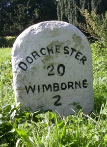 Milestone, grass area opp. St Huberts church