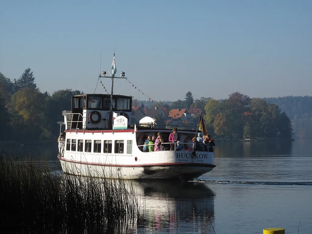 MS Scherri at the eastern shore of the Schermützelsee. The passenger ship „MS Scherri“ was built in 1879 by the Reiherstiegwerft in Hamburg. First named „Reiher“ the ship started up on the Alster. On the Schermützelsee it is in operation since 1992. The Schermützelsee is a lake in Buckow, District Märkisch-Oderland, Brandenburg, Germany. The lake covers 137 hectare and is the largest water in the hill country „Märkische Schweiz“ and in the Märkische Schweiz Nature Park.