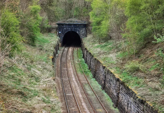 The south portal of the Bramhope Tunnel at grid reference SE24144077 in Bramhope, West Yorkshire, England. The rock, particularly at this end of the tunnel, proved difficult and expensive to blast during its construction in the 1850s. Flooding and subsidence also presented a constant threat - it has been estimated that in total some 1,563,480,000 gallons of water were pumped out of the workings during construction due to the gradient sloping downwards from this point as the tunnel snakes over two miles to the Arthington portal on the north side.
