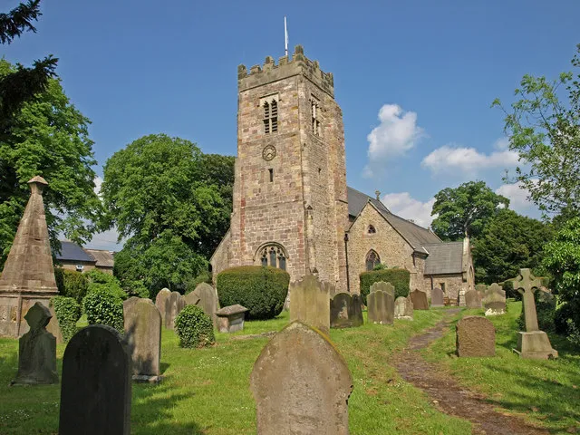 Parish Church of Saint Mary, Bolton-on -Swale St. Mary's Church is at the easternmost end of the parish. Situated in the small village of Bolton on Swale. Built on the site of previous Norman and Saxon structures. The present building was erected by the brethren of the Abbey of St Mary of York, probably during the first half of the 14th. century. The church was enlarged and restored in 1859. In the vestry a curious stone roof exists which is apparently a portion of the original Saxon structure. In the graveyard is the tomb of Henry Jenkins(on the left edge of frame) who, it is claimed, lived to be over 160 years old!