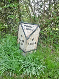 Milepost, Lytchett Minster,  opposite Church and School