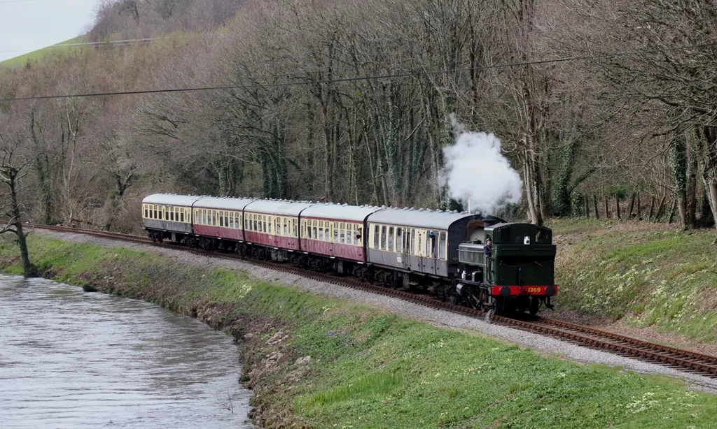 Pannier tank 1369 runs alongside the River Dart as it makes its way from Buckfastleigh towards Totnes on the South Devon Railway.