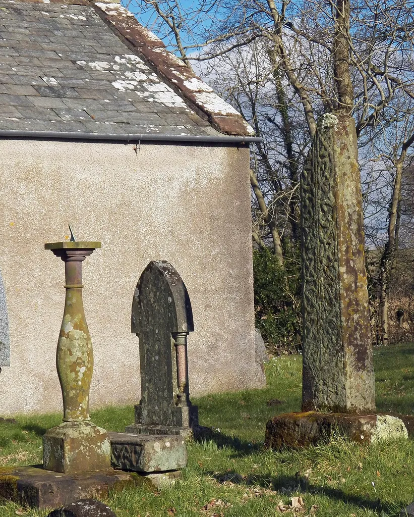 View of the two cross shafts at Waberthwaite, Cumbria. The large shaft is 10th century or earlier (Collingwood) and is Norse with Anglian characteristics. The second cross shaft is lying on the steps of the sundial.