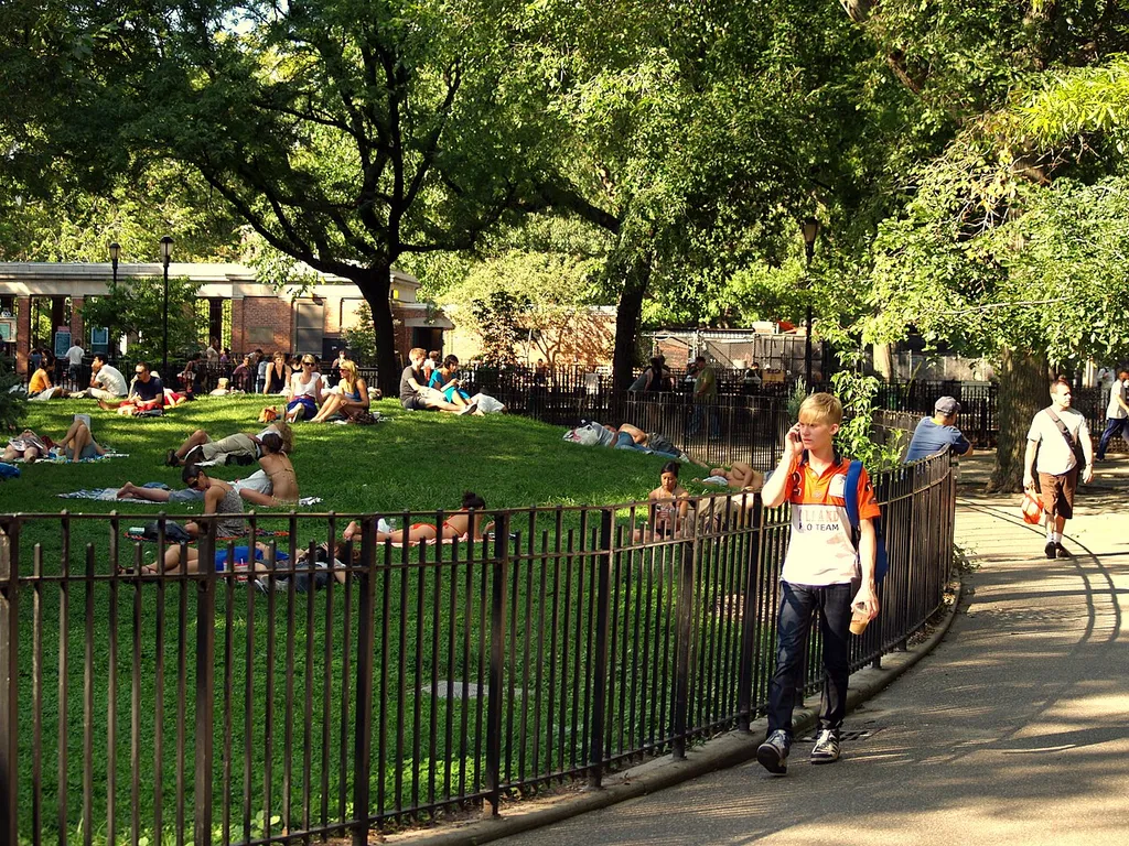 The central knoll at Tompkins Square Park in New York City where people sunbathe and relax.