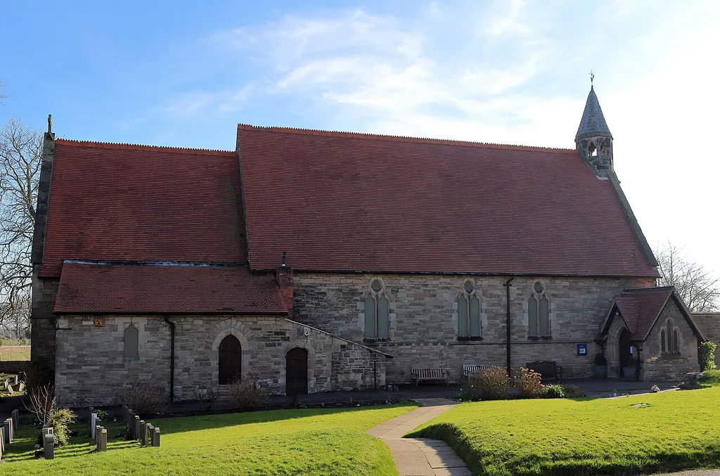 View of the north side of Christ Church, Barnston, from the main path through the churchyard.