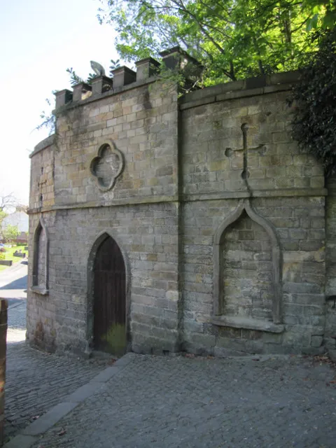 Disused archway at the entrance to the to St Laurence's parish churchyard, Chorley, Lancashire, seen from the west