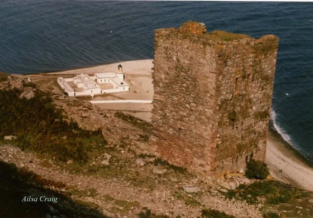 Ruined castle on Ailsa Craig, lighthouse below on shore