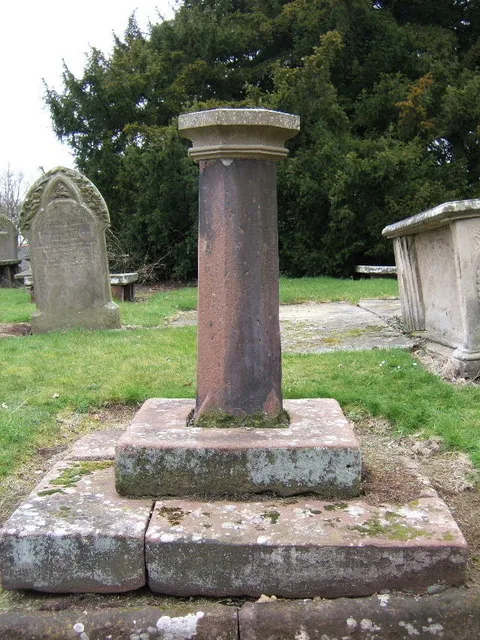 Sundial in St Bartholomew's parish churchyard, Great Barrow, Cheshire. The sundial was inscibed with the date 1705, but is missing from the top of the pillar. The shaft probably belongs to a churchyard cross that was broken in 1613.