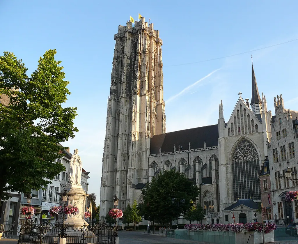 The flat-topped silhouette of the St-Rumbold's Cathedral's tower is easily recognizable and dominates the surroundings. Statue of Margaret of Austria, Duchess of Savoy on the Schoenmarkt in Mechelen.