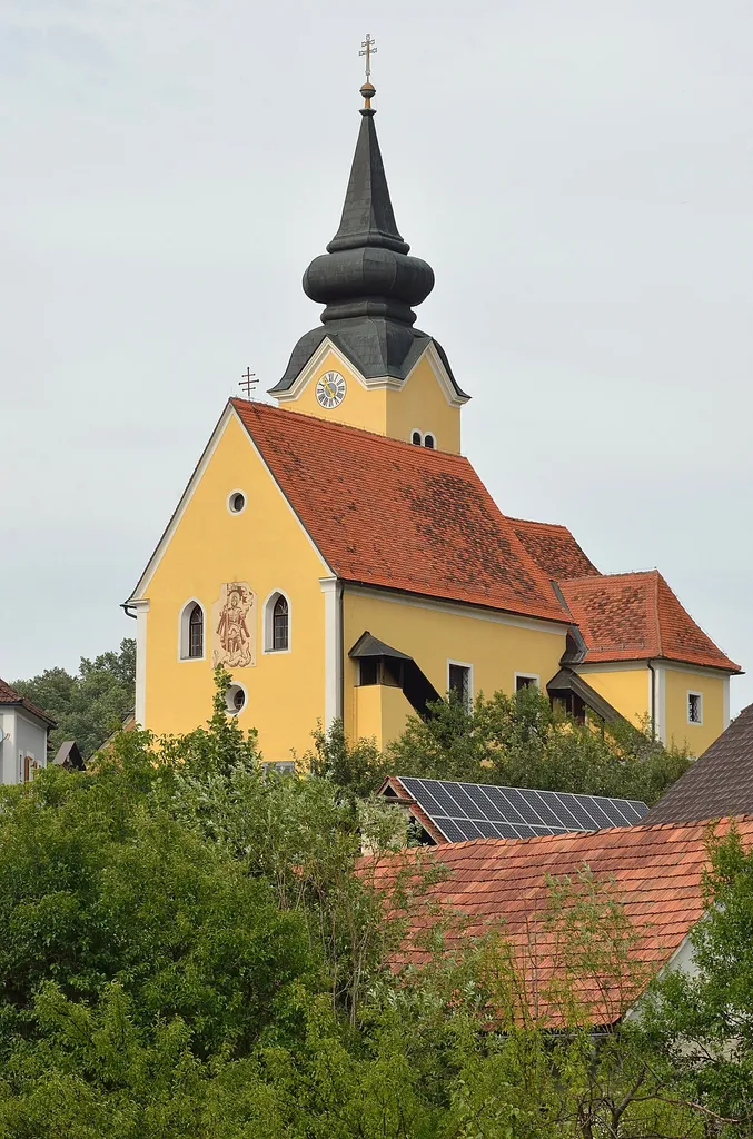 Parish church St. George and cemetery in Großklein, Styria. As seen from SW. At the west face of the church there is a sgraffito of Saint George and the dragon.