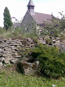 Wayside cross base on south side of the churchyard wall at Scawton
