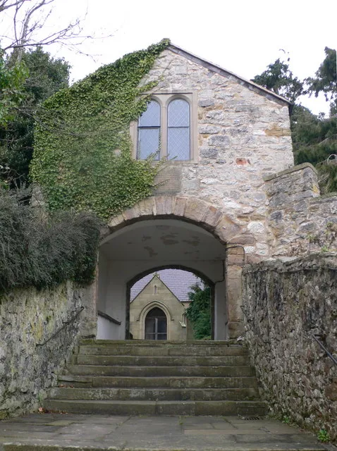 Southern lych gate to Whitford church This is the main entrance to the church. It has an upper room formerly used for meetings which is accessible by a flight of stone steps on the west side. The plaque below the window refers to Hugh Edwards of Mertyn (d.1624), who bequeathed money towards the building of the 'porch'.
