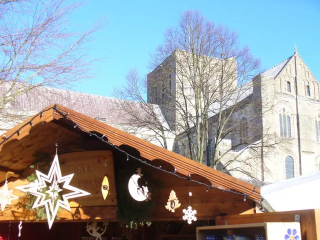 Star Appearance A chalet at Winchester Christmas Market occupied by "Finde Fuchs" which sells Polish pottery and wooden decorations. In the background is the tower of Winchester Cathedral.