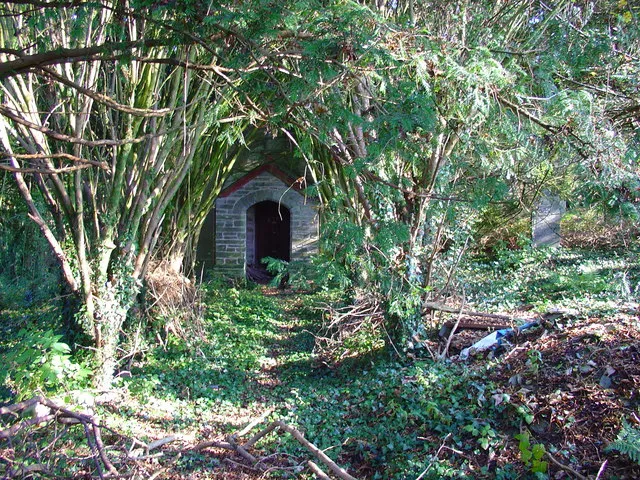Penrydd Parish Church Porch of the abandoned church buried in undergrowth.