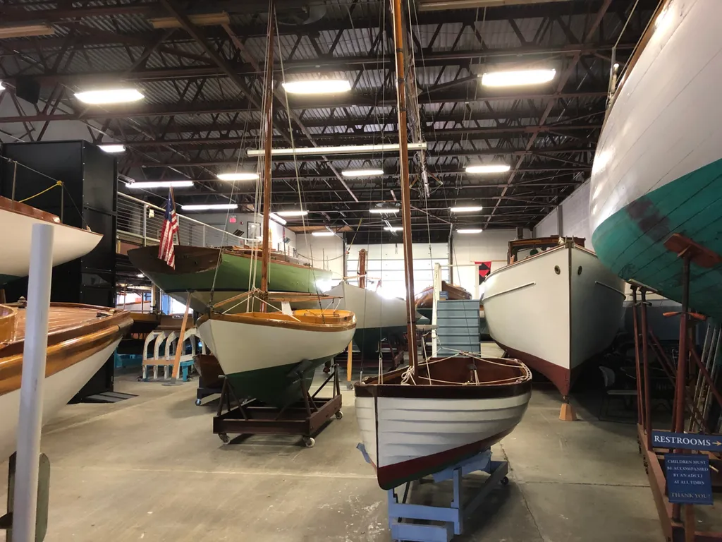A large hanger full of a wide range of historic Herreshoff sailing boats.