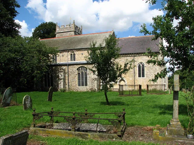 The church of St John the Baptist. The church of St John the Baptist > 923351 - 923384 is set back from The Street (B1145) and totally hidden behind tall trees so that it can very easily be overlooked. The existence of a church on this site is documented since Saxon times but the building has been much altered since. The large buttresses on the south side hide reinforced concrete beams, which were inserted to check the ongoing subsidence on this side of the building. Curiously, the tower - added during the 14th century - is located on the north side, so as not to cast its shadow onto the famous west window > 923387 - 923389 which contains much of its original glass and is dated to about 1340. This window is the largest surviving example of C14 glass in Norfolk. C14 glass can also be found in the south aisle east window > 923378. Nave and chancel roofs were rebuilt in the 19th century but the priest door retains its Norman shafts and arch, and both aisle roofs > 923371 are original C15 as are the octagonal font > 923392 and the wineglass pulpit > 923358. The elaborately carved stone coffin lids > 923396 - found at Mileham Hall and reset by the north and south door - are believed to be older. The modern east window > 923355 is by Mrs Pippa Blackall AMPG and was inserted in 2004. The church also houses a C16 brass and a number of memorials and ledger slabs > 923364 - 923368. Due to recent vandalism the church is now kept locked. See also: http://www.norfolkchurches.co.uk/mileham/mileham.htm