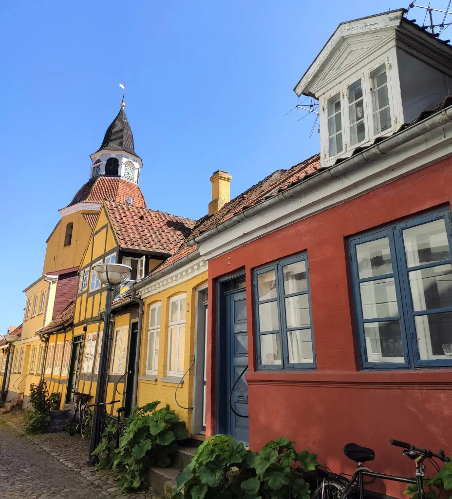 Tårngade allyway in Faaborg, Denmark with the Faaborg Clock Tower in the background, photographed 30 May 2021