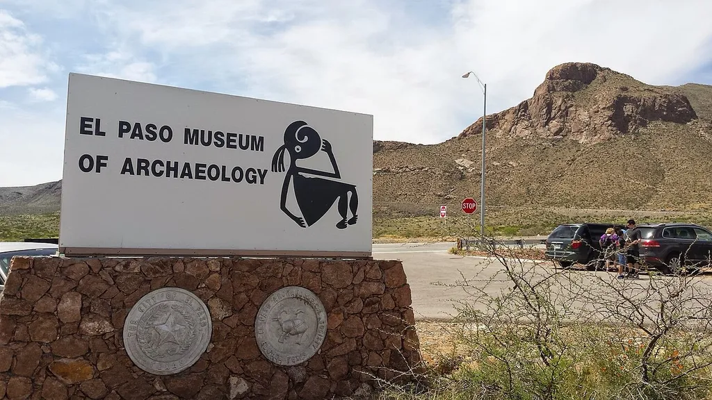 The sign outside of the El Paso Museum of Archaeology with the Franklin Mountains in the background.
